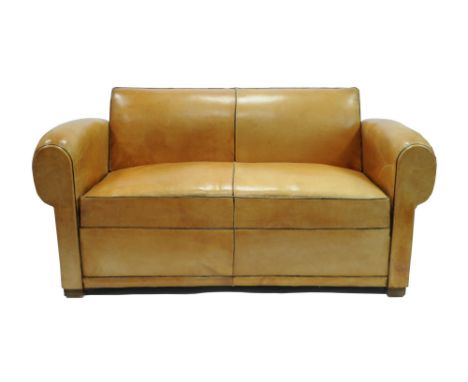 A 20th century French tanned leather folding sofa/day bed, the rolled arms before a tablet back with mid brown borders