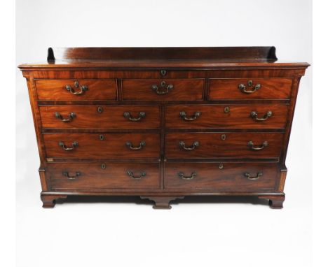 A George III mahogany and inlaid Lancashire mule chest, circa 1780, with low panelled back, the rectangular bevelled top encl