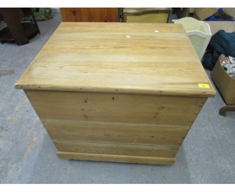 A pine storage trunk with iron carrying handles, hinged lid, on plinth base and wheelsLocation: G 