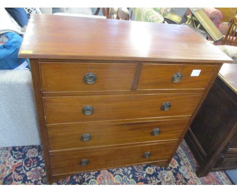 An early 20th century walnut chest o f two short and three long drawers having ring shaped handles and standing on castors, 4