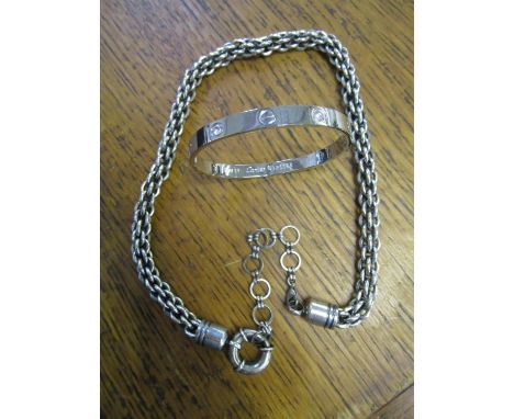 A fashion house style love bangle and a heavy metal modern fashion style chain necklace 
