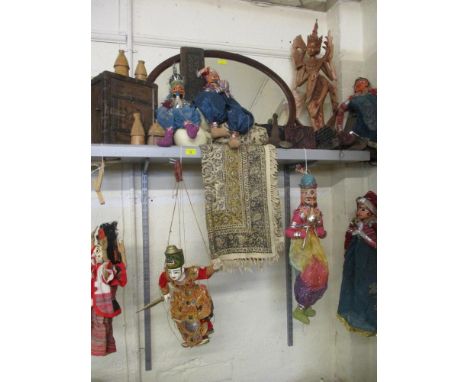 A quantity of Asian puppets, fabrics, a Thai carved treen figure, a hardwood box, a carved panel, printing blocks and an earl