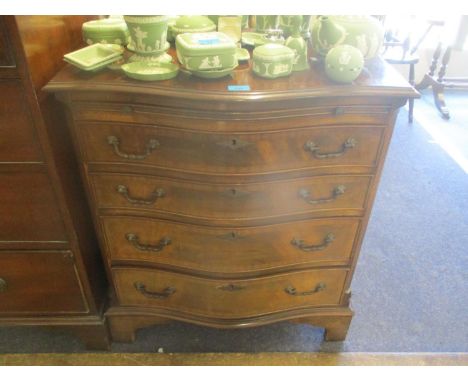 A reproduction serpentine small chest of drawers having a brush slide and four graduated drawers, 31 1/2" x 28"Location: C-R 