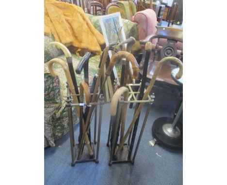 Two stick stands containing mixed umbrellas and walking sticks to include one having an ivory top and silver rimLocation: RWF