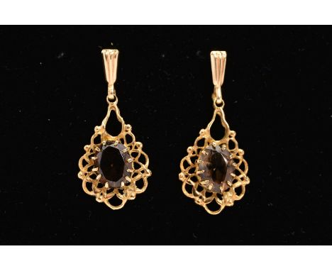 A PAIR OF 9CT GOLD SMOKY QUARTZ DROP EARRINGS, each designed as an oval smoky quartz within a claw setting to the openwork sc