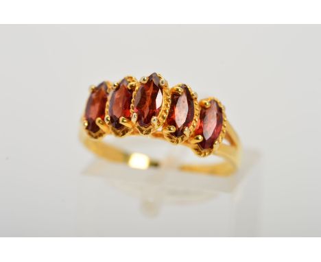 A 9CT GOLD GEM DRESS RING, designed as five marquise shape red gems, assessed as garnets set in a stepped line within claw se