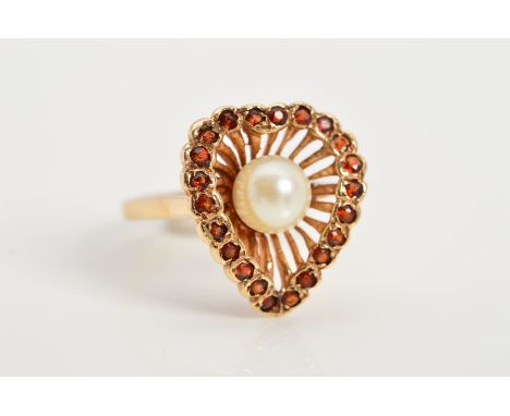 A 9CT GOLD CULTURED PEARL AND GARNET DRESS RING, designed as a central cultured pearl within a concave wirework pear shape su