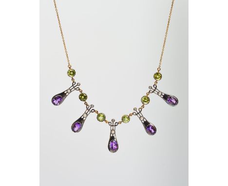 AN AMETHYST, PERIDOT, DIAMOND AND SPLIT PEARL NECKLACE, designed as five tapered and scrolling panels each set with an oval a