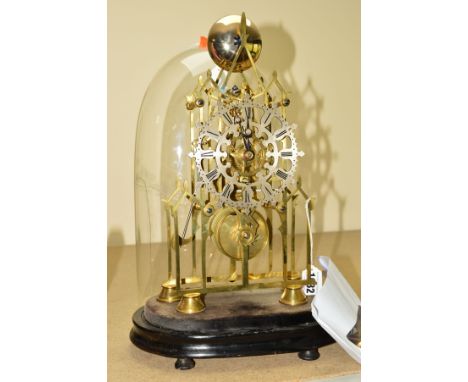 A LATE 19TH CENTURY BRASS SKELETON CLOCK, of cathedral form, the pinnacle with bell which is struck by an axe headed hammer, 