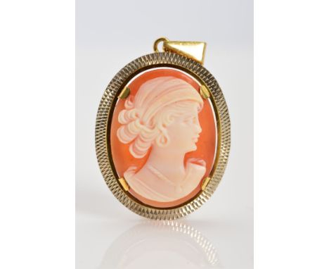 A CAMEO PENDANT, of oval outline, the cameo depicting a woman in profile to the diamond cut pattern surround, the tapered sus