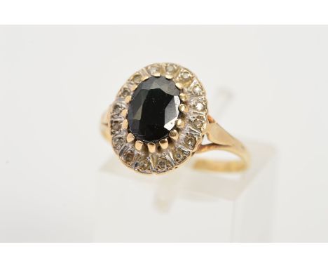 A 9CT GOLD SAPPHIRE AND DIAMOND CLUSTER RING, designed as a central oval sapphire within an illusion set, single cut diamond 