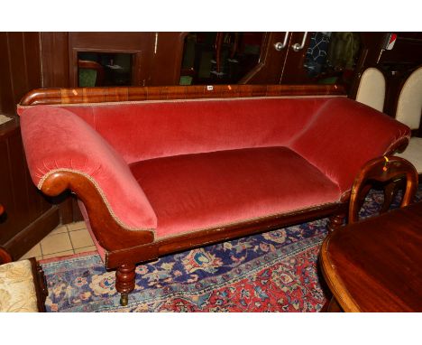 AN EARLY VICTORIAN WALNUT SCROLLED SOFA on four turned legs, the front brass caps enclosing ball bearing, the back with penny