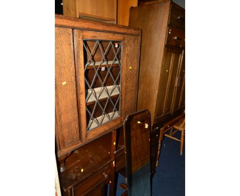 AN OAK LEAD GLAZED SINGLE DOOR BOOKCASE, together with an oak tall boy, oak desk and a cheval mirror (4)