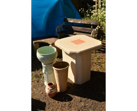 A SQUARE CREAM COMPOSITE GARDEN TABLE with canted corners on a seperate base, height 73cm x width 68cm, together with two vas