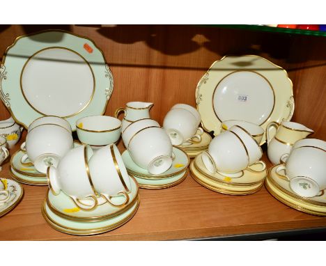 TWO WEDGWOOD TEASETS, different colourway, one yellow banding, the other green banding, both gilt trim, both comprising cake/