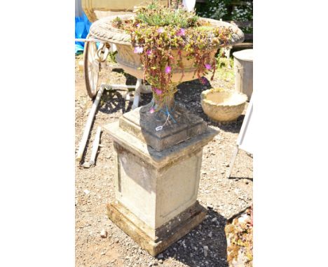 A LARGE CIRCULAR STONE PLANTER, lattice perimeter on a seperate base supported on a square composite column, diameter 80cm x 