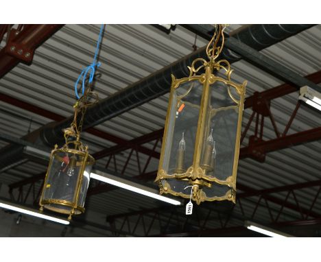 A BRASS HEXAGONAL HANGING LANTERN with glass panels, together with two various other brass hanging lanterns (3)