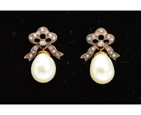 A PAIR OF CULTURED PEARL AND DIAMOND DROP EARRINGS, each designed as a cultured pearl drop suspended from a bow shape panel a