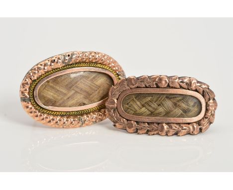 TWO LATE VICTORIAN MEMORIAL BROOCHES, both of elongated oval outline with a central woven hair panel, the first with a herrin