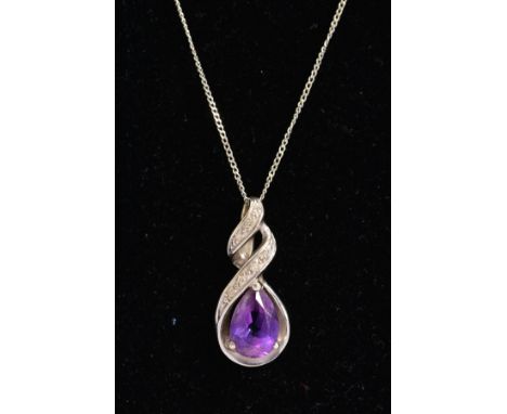 A 9CT WHITE GOLD AMETHYST AND DIAMOND PENDANT AND CHAIN, the pendant designed as a pear shape amethyst to the scrolling top m