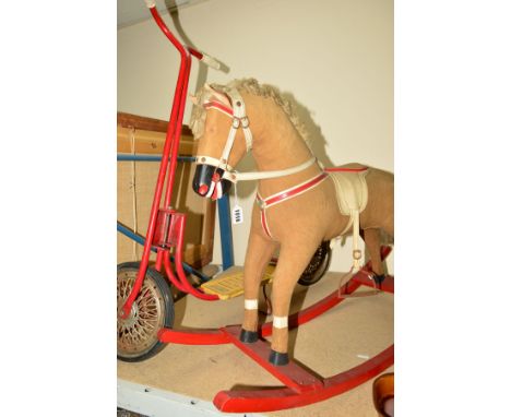 A WOODEN ROCKING HORSE, plush covered, fabric mane and tail, painted wooden mouth and hooves, plastic eyes (one missing) leat