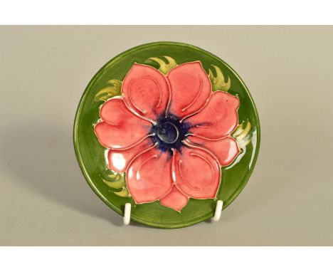 A MOORCROFT POTTERY TRINKET DISH, 'Anemone' pattern on green ground, impressed marks to base, diameter 11.5cm