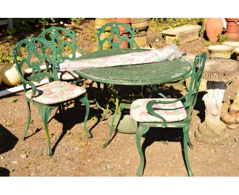 AN ALUMINIUM CIRCULAR PAINTED GREEN GARDEN TABLE on four legs with under tier shelf, together with four matching chairs and a