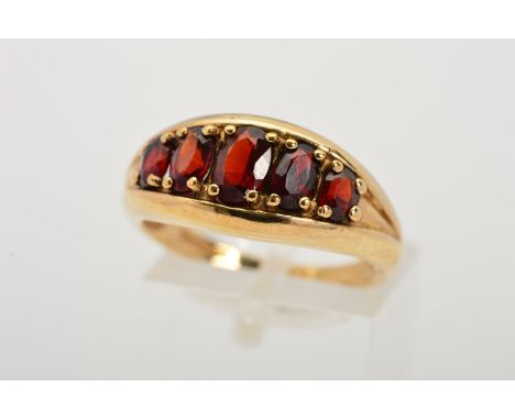 A 9CT GOLD GARNET DRESS RING, designed as a line of five graduated oval garnets with 9ct gold hallmark for Birmingham, ring s