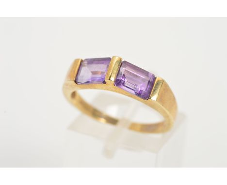 A 9CT GOLD AMETHYST RING, designed as two rectangular amethysts horizontally set at an upward angle, with central bar, with 9
