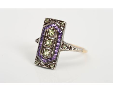 AN AMETHYST, DIAMOND AND PERIDOT DRESS RING, the rectangular panel set with a carved vertical line of three peridots within a