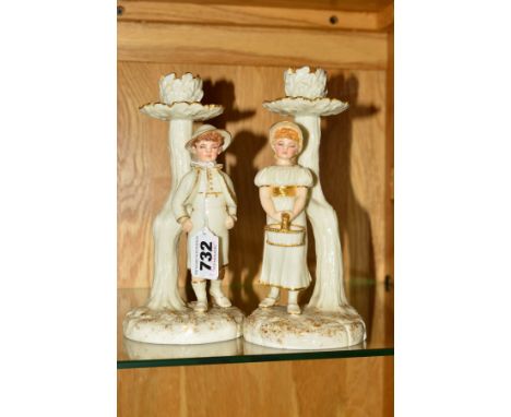 A PAIR OF ROYAL WORCESTER KATE GREENWAY STYLE FIGURAL CANDLESTICKS, modelled by James Hadley, white with gilt details, impres