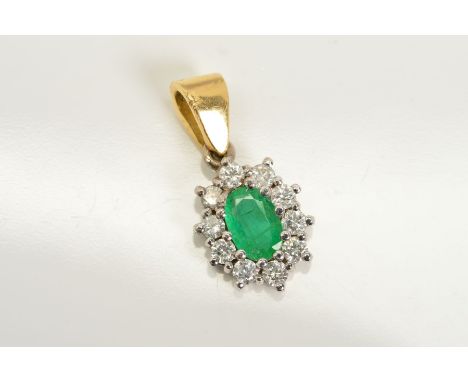 AN 18CT GOLD, EMERALD AND DIAMOND CLUSTER PENDANT, designed as a central oval emerald within a claw set brilliant cut diamond