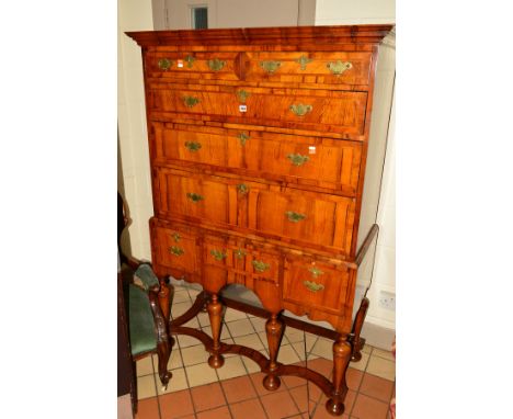 A REPRODUCTION WILLIAM AND MARY STYLE CHEST ON STAND, with an overhanging cornice, fitted with two short and three long drawe