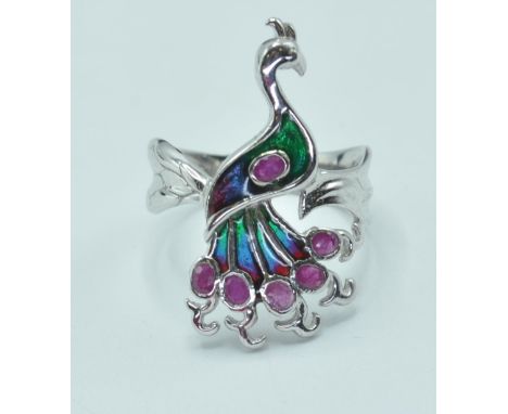 A stamped 925 silver ladies dress ring having a plique a jour enamel peacock to the top. Stamped 925 to the inner band. Size 