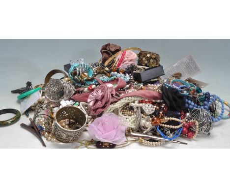 A collection of vintage costume jewellery to include a wide selection of beaded necklaces, bangle bracelets, brooches, earrin