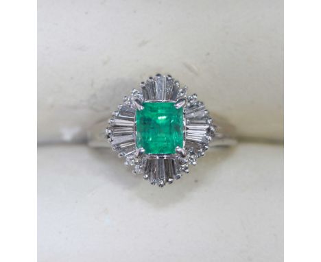 ADDENDUM: An emerald and diamond ballerina cluster ring, centrally set with an emerald estimated 1.58 carats, surrounded by b