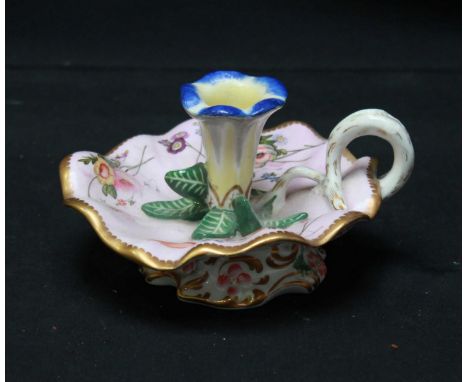 An early 19th century Spode porcelain chamber stick, painted with flowers on a pink ground, with gilt rim, the bowl formed as