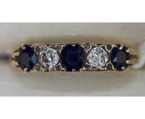 A sapphire and diamond five stone ring, with scrolled yellow metal mount.