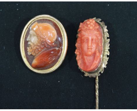 A Victorian carved coral bust of a young lady, set in a yellow metal stick pin mount; together with a Victorian carved Cornel