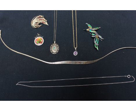 A group of jewellery including a 9ct gold pendant on chain; a three-tone gold necklace; a 9ct gold brooch; a silver gilt pend