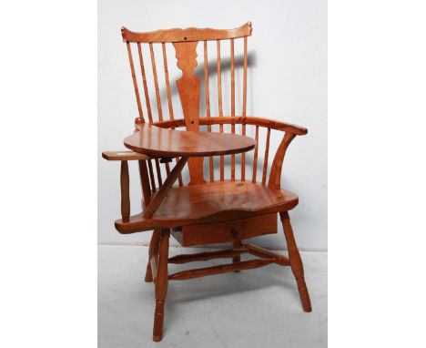 A good quality contemporary stick back yew wood Windsor chair, with integrated drawer below the seat and swivel table section