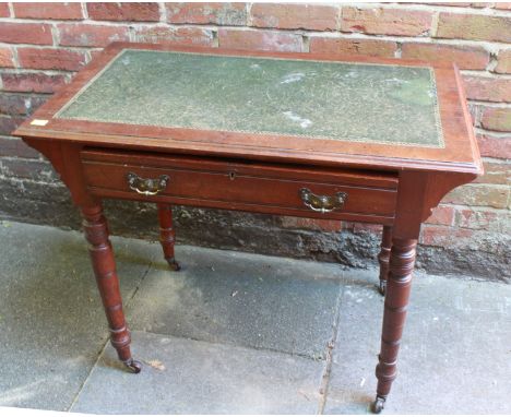 An Edwardian stained walnut side table desk, with inset green gilt-tooled leather scribe, single frieze drawer, raised on tur