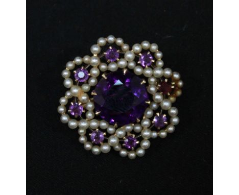 A 14ct gold, seed pearl and amethyst brooch, of circular entwined form.