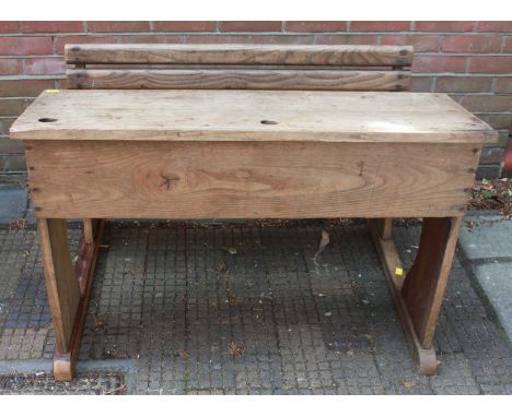 A child's early 20th century oak and ash double school desk with integrated bench seat. 105 cm wide.