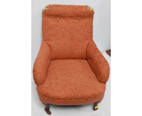 An early 20th century armchair, recently re-upholstered with brick-red and gold foliate upholstery, on cabriole supports to c