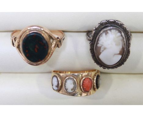 An unusual 14K gold ring set with five miniature cameos; a hardstone seal ring; and a white metal cameo ring (3).