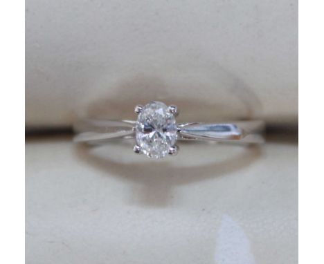 An 18ct white gold solitaire diamond ring four claw set with an oval diamond weighting 0.33 carats, approximate total weight 