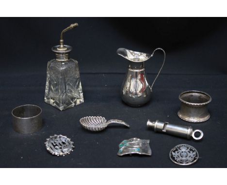 A small collection of silver items including a Police whistle, napkin rings, atomizer, caddy spoon, enamel belt buckle and tw