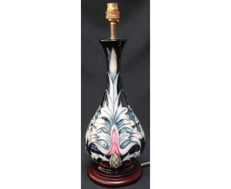 A Moorcroft 'Snakeshead' table lamp with bulbous body and slender neck, with tube-lined decoration. On a wooden base, with sh