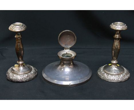 A George V silver capstan inkwell, hallmarked Birmingham 1925, lacking liner, together with a pair of embossed silver candles